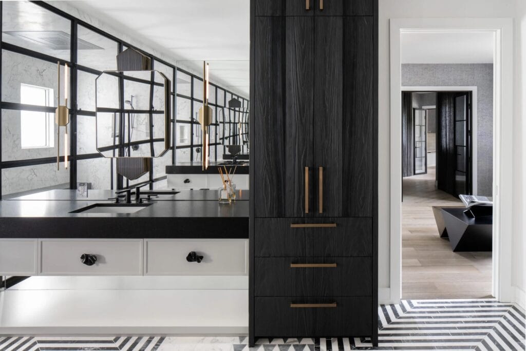 Award-winning bathroom featuring black and white finishes, modern mirrors and sinks, textured wall coverings, and sculptural lighting in Safety Harbor remodel.