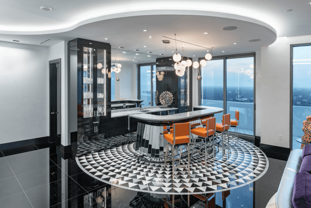 Luxury residential home bar design with dark materials, sculptural lighting, and architectural detailing.
