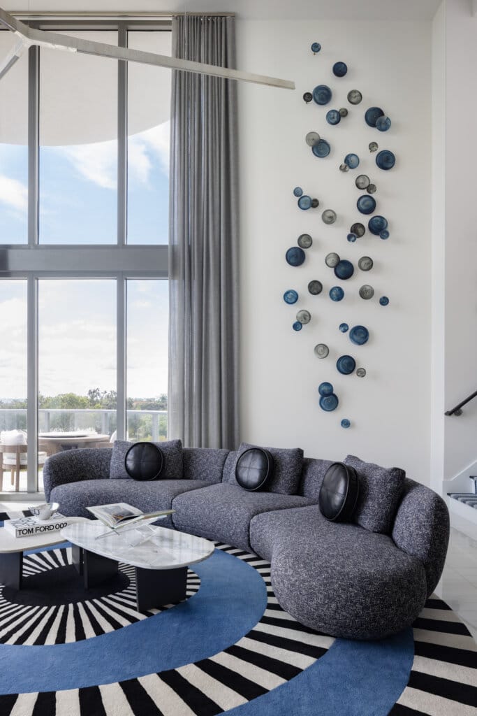 Luxury living room interior design in Tampa Bay featuring sculptural seating and layered textures